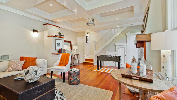 beige walled house with a white ceiling with some white sofas and brown wooden furniture