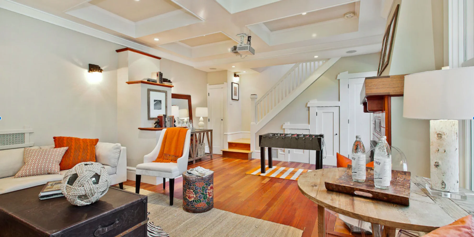 beige walled house with orangie wooden floor and white stairs